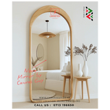 Wooden floor mirror in a room setting with decor elements, featuring the brand 'Canvas Guy'.